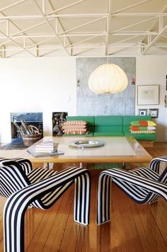 interior mood board modern power office interior with black and white stripped chairs and green couch at the back
