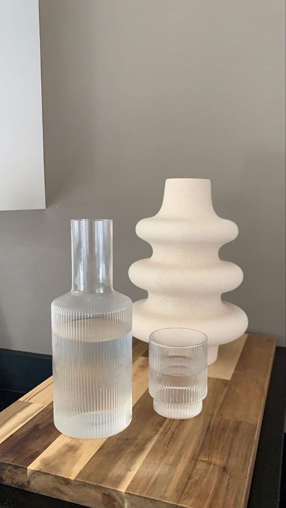 modern vases on wooden table with warm grey wall at the back