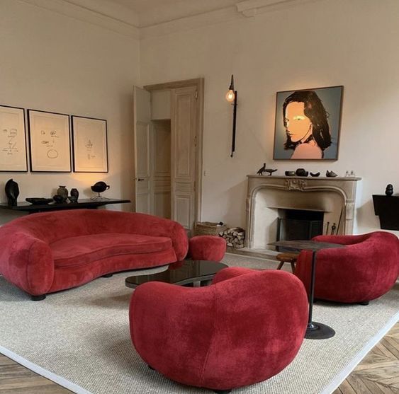 big room with art on walls and modern burgundy couch