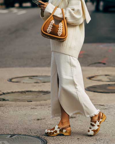 cow printed clogs styled with beige-hued outfit