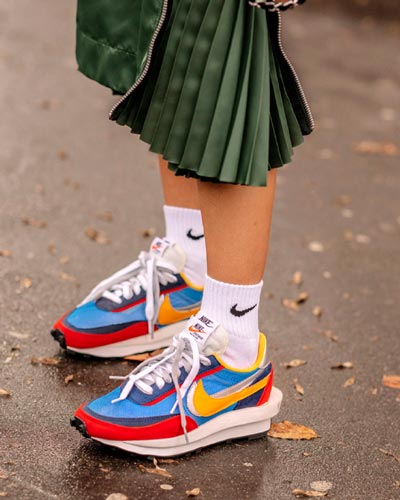 colourful nike sneakers styled with pleated dress