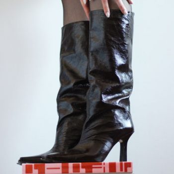 square-toe boots trend - close up of glossy square-toe boots 2022 miista on top of the fashion magazines